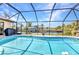 Refreshing swimming pool enclosed with a screen, providing privacy and a clear view of the waterfront at 4473 Sweetbay St, Port Charlotte, FL 33948