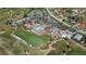 Aerial view showcasing the community clubhouse with pool, tennis courts, and golf course at 5061 San Rocco Ct, Punta Gorda, FL 33950