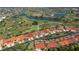 Aerial view of community showcasing golf course, lakes, and red-tiled roofs at 5061 San Rocco Ct, Punta Gorda, FL 33950