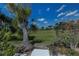 The property features a view of a lush green golf course framed by the beautiful blue sky and landscaping at 5061 San Rocco Ct, Punta Gorda, FL 33950