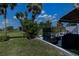 This backyard features outdoor seating, tropical landscaping, a built-in privacy screen, and views of the golf course at 5061 San Rocco Ct, Punta Gorda, FL 33950