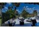 This cozy backyard features outdoor seating, tropical landscaping, and views of the golf course at 5061 San Rocco Ct, Punta Gorda, FL 33950