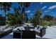 This backyard features outdoor seating, tropical landscaping, and views of the lush green golf course at 5061 San Rocco Ct, Punta Gorda, FL 33950