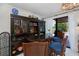 Well-appointed bar area featuring a dark wood bar, seating, built-in shelves, and access to the backyard at 5061 San Rocco Ct, Punta Gorda, FL 33950