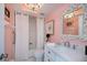 The stylish bathroom features a marble vanity with a vintage mirror over a shower and tub combination at 5061 San Rocco Ct, Punta Gorda, FL 33950