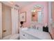 This charming bathroom features a white vanity and an ornate mirror over a tub and shower combination at 5061 San Rocco Ct, Punta Gorda, FL 33950