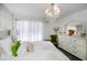 Cozy bedroom with chandelier lighting, white dresser and sheer curtains for natural light at 5061 San Rocco Ct, Punta Gorda, FL 33950