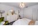 Comfortable bedroom features a chandelier, white dresser and serene atmosphere at 5061 San Rocco Ct, Punta Gorda, FL 33950