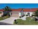 Inviting single-Gathering home featuring a terracotta roof, manicured lawn, and a spacious driveway leading to a two-car garage at 5061 San Rocco Ct, Punta Gorda, FL 33950