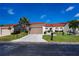 Inviting single-story home with a well-manicured lawn, two-car garage, and classic exterior design at 5061 San Rocco Ct, Punta Gorda, FL 33950