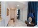 Bright hallway offers access to several rooms and features white-tiled floors at 5061 San Rocco Ct, Punta Gorda, FL 33950