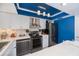 Stylish kitchen featuring stainless steel appliances, white marble countertops, and blue accent lighting at 5061 San Rocco Ct, Punta Gorda, FL 33950