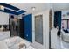 Charming kitchen features a pantry door, stainless steel refrigerator, and blue accent walls at 5061 San Rocco Ct, Punta Gorda, FL 33950