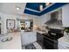 Modern kitchen features stainless steel appliances, white cabinets, and an open layout at 5061 San Rocco Ct, Punta Gorda, FL 33950