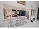 Kitchen boasts sleek white countertops, white cabinets, and barstool seating at 5061 San Rocco Ct, Punta Gorda, FL 33950