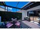 Stylish outdoor patio featuring a black and white checkered rug, modern furniture, and views of the surrounding area at 5061 San Rocco Ct, Punta Gorda, FL 33950