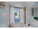 Bathroom shower with a sliding glass door opens to an outdoor patio at 5061 San Rocco Ct, Punta Gorda, FL 33950