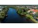 Beautiful water view with a private dock, mature trees, and lush landscaping that gives a peaceful vibe at 5061 San Rocco Ct, Punta Gorda, FL 33950
