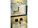 Bathroom featuring decorative mirror, chrome faucet and black and yellow tile at 535 Lindley Ter, Port Charlotte, FL 33952