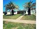 Inviting single-story home featuring a well-manicured lawn and mature landscaping at 535 Lindley Ter, Port Charlotte, FL 33952