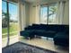 Bright living room featuring large windows, a comfortable sofa, and neutral decor at 535 Lindley Ter, Port Charlotte, FL 33952