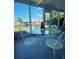 Enclosed sunroom with serene water views, glass table, and metal chairs at 535 Lindley Ter, Port Charlotte, FL 33952