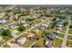 Scenic aerial view of a charming residential area featuring tidy homes, lush greenery, and curved streets at 558 Azalea Drive, Port Charlotte, FL 33952