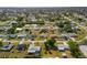 Expansive aerial view of a quiet residential neighborhood showcasing neatly arranged homes and tree-lined streets at 558 Azalea Drive, Port Charlotte, FL 33952