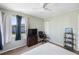 Cozy bedroom features neutral carpet and paint, ceiling fan, and dresser with TV at 558 Azalea Drive, Port Charlotte, FL 33952
