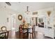 Cozy dining area features hardwood floors and seamless access to the living room, bathed in natural light at 558 Azalea Drive, Port Charlotte, FL 33952