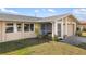 Welcoming exterior shot of the home highlighting the entrance, attached garage, and verdant front yard at 558 Azalea Drive, Port Charlotte, FL 33952