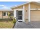 Close-up showcasing the home's entrance with screened porch and a well-manicured lawn at 558 Azalea Drive, Port Charlotte, FL 33952