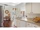 Open concept kitchen with white cabinetry, stainless sink and view into dining area at 558 Azalea Drive, Port Charlotte, FL 33952