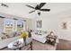 Bright living room with large window, neutral carpet, ceiling fan and comfortable seating at 558 Azalea Drive, Port Charlotte, FL 33952