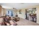 Open-concept living room showcases a cozy seating area, seamlessly flowing into the adjacent dining space at 558 Azalea Drive, Port Charlotte, FL 33952