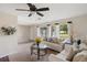 Bright living room with white sofa, large windows, and neutral tones creating a welcoming atmosphere at 558 Azalea Drive, Port Charlotte, FL 33952