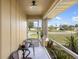 Inviting outdoor porch with outdoor seating, lush planters and a pleasant view of the neighborhood at 558 Azalea Drive, Port Charlotte, FL 33952