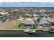Aerial view of the property highlighting its waterfront location, pool, and boat dock in a vibrant neighborhood at 571 Port Bendres Dr, Punta Gorda, FL 33950