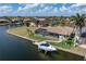 Aerial shot of the backyard with boat dock, screen enclosed pool, landscaping, and waterfront views at 571 Port Bendres Dr, Punta Gorda, FL 33950