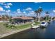 Exterior shot of a beautiful backyard featuring a pool, boat dock, and waterfront view, perfect for entertaining at 571 Port Bendres Dr, Punta Gorda, FL 33950
