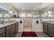 Lavish bathroom with granite counters, dual vanity, and a seamless glass shower enclosure with bench seating at 571 Port Bendres Dr, Punta Gorda, FL 33950