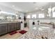 Luxurious bathroom featuring granite countertops, dual sinks, and a glass-enclosed shower at 571 Port Bendres Dr, Punta Gorda, FL 33950