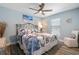 Charming bedroom with a decorative metal-framed bed, ceiling fan, and serene blue walls at 571 Port Bendres Dr, Punta Gorda, FL 33950