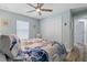 Comfortable bedroom featuring a queen bed, a ceiling fan, and a closet with sliding doors at 571 Port Bendres Dr, Punta Gorda, FL 33950