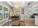 Chandelier-lit dining area with views into the home's living room and out to a serene water view at 571 Port Bendres Dr, Punta Gorda, FL 33950