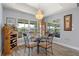 Bright dining room featuring a chandelier, large windows with water view, and stylish furnishings at 571 Port Bendres Dr, Punta Gorda, FL 33950