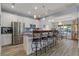 Modern kitchen featuring stainless steel appliances, granite countertops, and bar seating for casual dining at 571 Port Bendres Dr, Punta Gorda, FL 33950