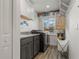 Efficient laundry room with cabinets, sink, washer, dryer, and shelving for ample storage at 571 Port Bendres Dr, Punta Gorda, FL 33950