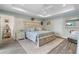 Spacious main bedroom with tray ceiling, wood-look floors, and a coastal-inspired decor at 571 Port Bendres Dr, Punta Gorda, FL 33950