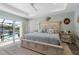 Bright main bedroom showing access to the outdoor pool area and serene backyard water view at 571 Port Bendres Dr, Punta Gorda, FL 33950